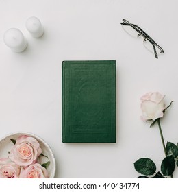 Green Book, Glasses, Pink Roses On White Background. Flat Lay