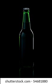 A Green Bottle Beer Over Black Background With Shadow