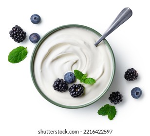 Green bowl of greek yogurt and fresh berries isolated on white background, top view