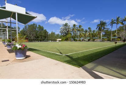 Green bowls or lawn bowls player ground which is natural grass or artificial turf surrounded with spot light, bench for players and public inside the stadium.