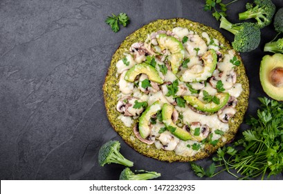 Green broccoli dough crust pizza with avocado, cheese. Low carbs, ketogenic diet vegan vegetarian pizza on slate background top view - Powered by Shutterstock