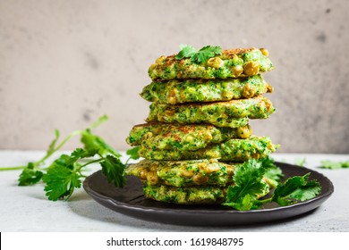 Green Broccoli And Pea Pancakes (cutlets) On Black Plate. Healthy Vegan Food Concept.