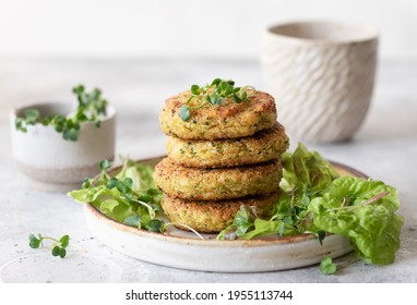 Green broccoli and quinoa burgers served with lettuce and microgreens. Tasty vegan food. close-up