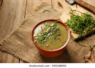 green broth with pepperoni and cabbage with top view on rustic wooden table - Shutterstock ID 1905188905