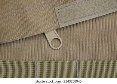 green brown fabric texture on a sticky buckle on a backpack