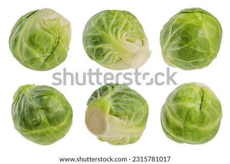 Green Brussels sprouts on a white isolated background. Flying vegetables isolated on white. Scatter a set of cabbage in different directions. Tasty and healthy food concept