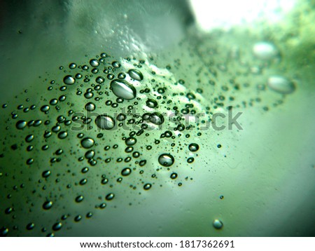 Green bubbles in glass (selective focus)