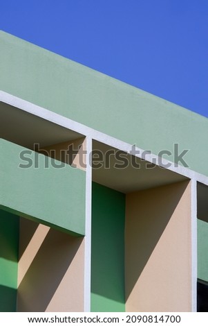 Green Building with Geometric Pattern of Shading Fin on Concrete Wall surface against blue sky. Home Exterior Architecture background in Vertical frame