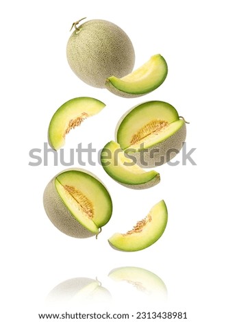 Green cantaloupe melon with cut slice flying in the air isolated on white background.