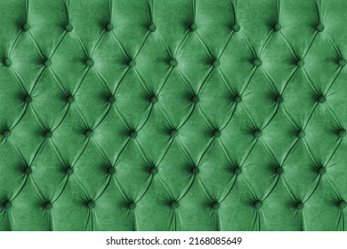 Green capitone checkered soft fabric textile decorative background with buttons. Classic retro Chesterfield style, luxurious upholstery buttoned texture for furniture, wall, headboard, sofa, couch
