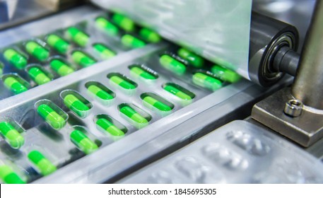 Green capsule medicine pill production line, Industrial pharmaceutical concept