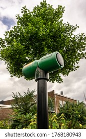 Green Car Charging Station Surrounded By Nature That Is Made Possible Trough Clean Driving.