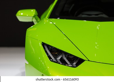 Green car on black background