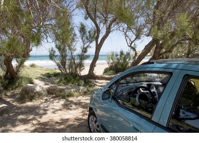 Green Car Park On Sand Beach Under The Trees