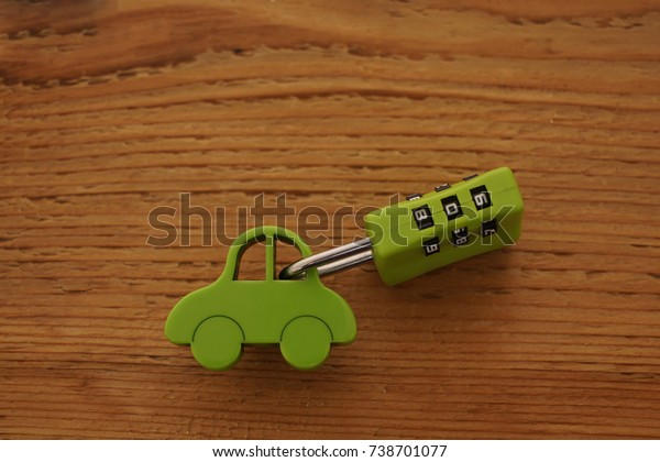 green car toy with  Key Code\
lock isolated on wooden background. car auto vehile Security       \
  