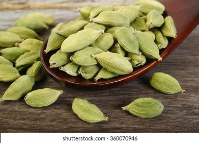 Green Cardamom Pods  In Wooden Spoon