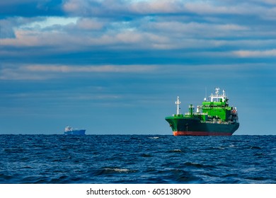 Green Cargo Ship Moored In Still Baltic Sea Water