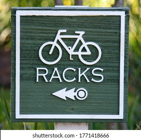 A Green Carved Wooden Sign Reading Racks