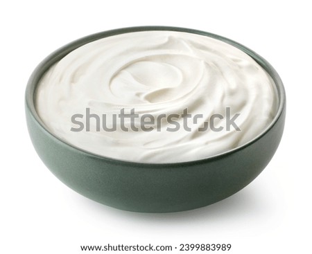 Green ceramic bowl of fresh greek yogurt or sour cream isolated on white background