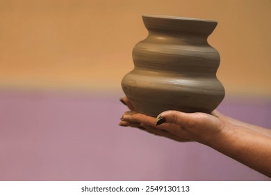 Green ceramic jug in hand close-up. Potter holds just hired by pottery. Ceramic skills. Sculptor sculpts products from clay. Workshop pottery. Copy space. - Powered by Shutterstock