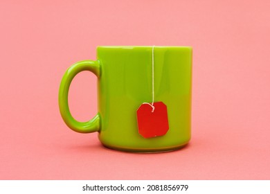 Green ceramic mug with red teabag label