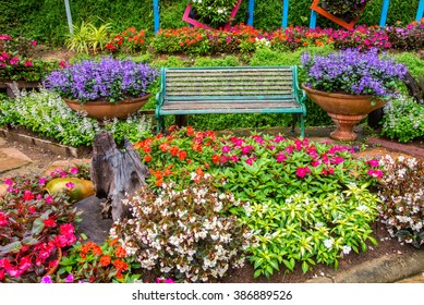 Green Chair In Beautiful Colorful Garden