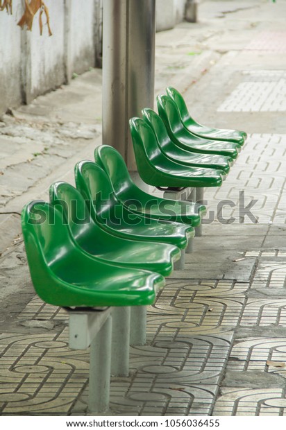 green chair in the bus\
stop