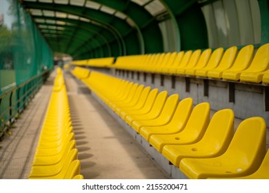 Green Chair For Spare Team Near Running Track On The Stadium. High Quality Photo