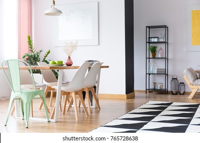 Green Chair Standing By A Wooden Table In A Monochromatic Flat Room Interior