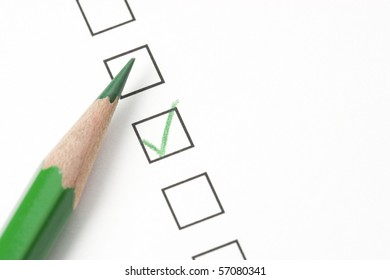 Green Check Box On Survey Box With Green Pencil. Focus On Tip Of Pencil