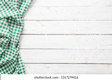 Green checkered kitchen tablecloth on wooden table. - Powered by Shutterstock