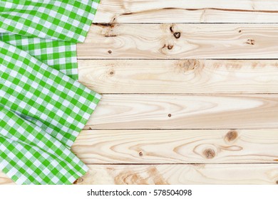Green checkered tablecloth on wooden table, top view - Shutterstock ID 578504098