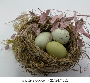 Green Chicken Eggs In A Straw Nest On White Background. Easter Holiday Eggs Natural Colour Background, Copy Space, Greeting Card, Postcard, Banner, Cover, Mockup, For Your Design