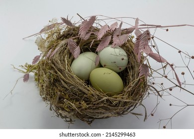 Green Chicken Eggs In A Straw Nest On White Background. Easter Holiday Eggs Natural Colour Background, Copy Space, Greeting Card, Postcard, Banner, Cover, Mockup, For Your Design