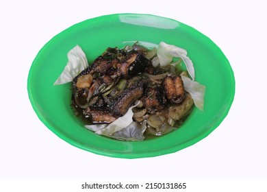 Green Chili Eel Dish On A Green Plate, Fried Eel Topped With Garlic And Cabbage. Clipping Path