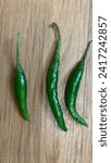 green chili pepper top view isolated on wooden background
