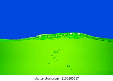 Green Chlorophyll Water Isolated On Dark Blue Background.