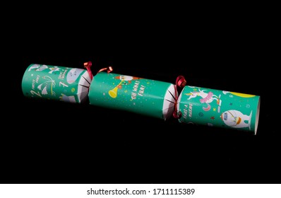 Green Christmas Cracker With Drawings On Against A Black Background. London - 19th April 2020