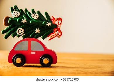 green Christmas tree on red toy car. Christmas holiday celebration concept. empty copy space for inscription. Holiday background.  - Powered by Shutterstock