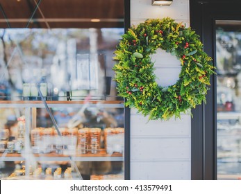 Green Christmas Wreath Displayed On Bakery Store Front