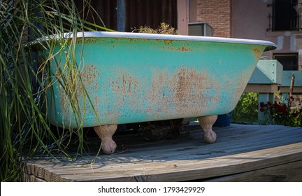 A Green Clawfoot Tub In A Garden