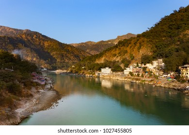 Green And Clean Ganges River At Sunset In Rishikesh, Uttarakhand, India.