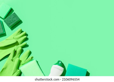 Green Cleaning Sponges, Gloves And Bottle Of Detergent On Color Background