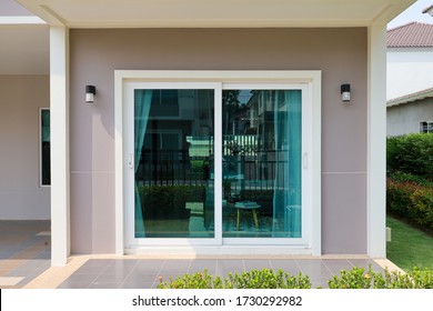 Green Clear Glass Attached To The Sliding Door And Wall Of The House.