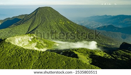 green cliff mountain peak in the morning a little fog