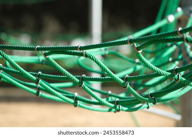 Green climbing rope net of the children's playground. Early childhood concept and children's playground - Powered by Shutterstock