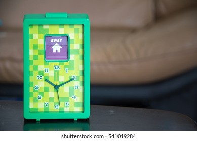 Green clock with note, away