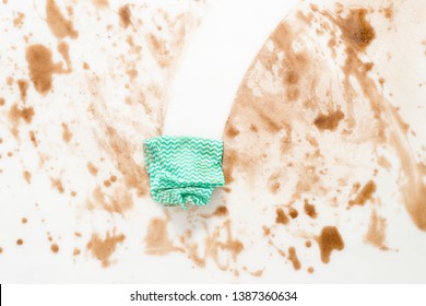 Green cloth or rag wiping clean a dirty counter top or floor