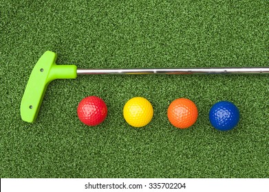 Green Club And Balls For Putt Putt On Artificial Turf