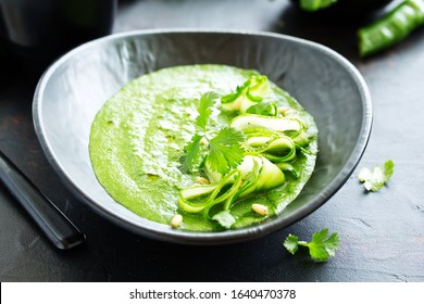 Green cold spinach and cucumber soup. Selective focus.